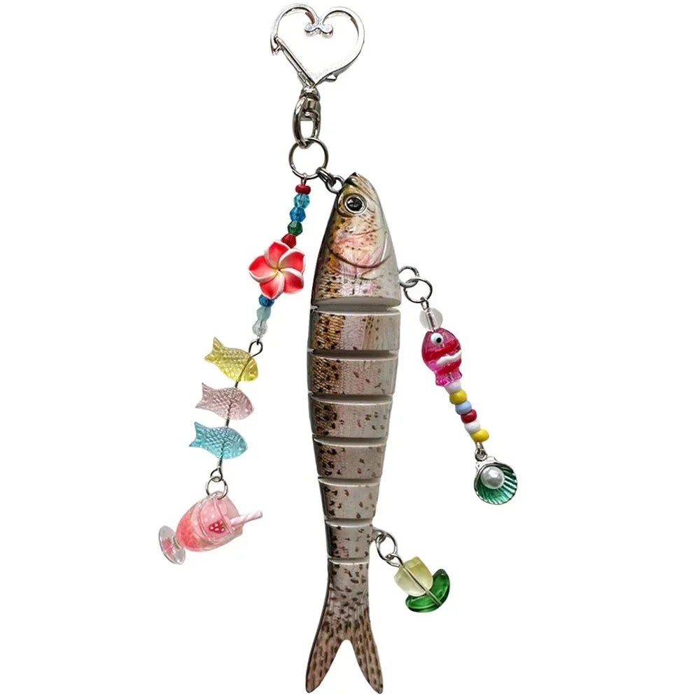 A silver simulation fish keychain with colorful beads and a heart charm.