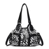 A black and white leopard print PU leather tote bag with an adjustable strap.