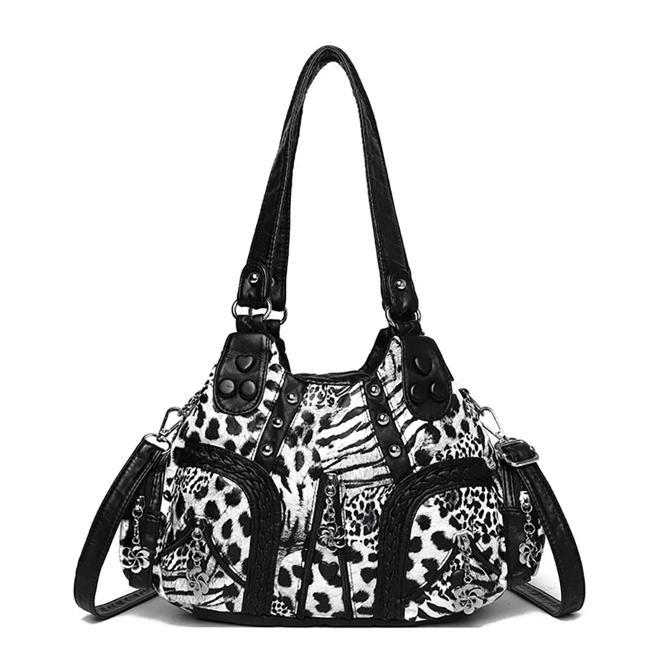 A black and white leopard print PU leather tote bag with an adjustable strap.