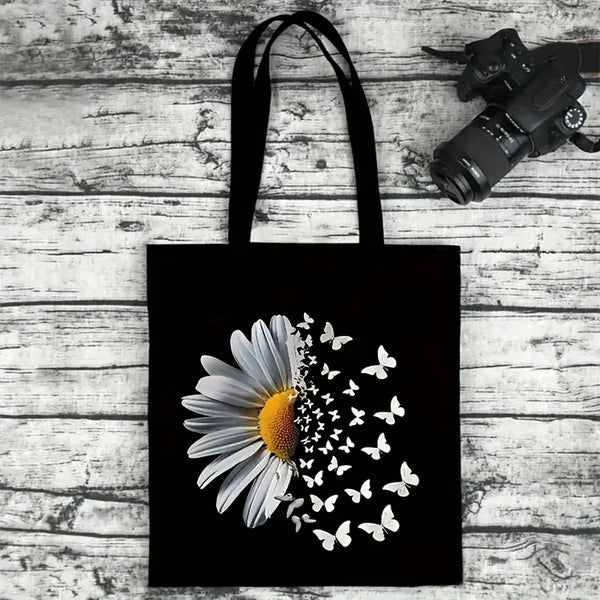 Black canvas tote bag featuring a white daisy with small white butterfly silhouettes.