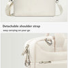 A cream-colored laptop sleeve featuring a detachable shoulder strap and a dual zipper closure.