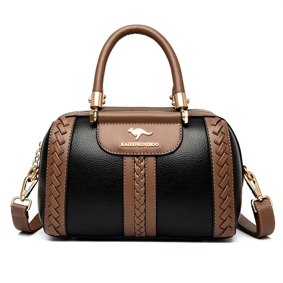 A brown leather shoulder crossbody bag with a woven pattern and gold hardware against a white background.