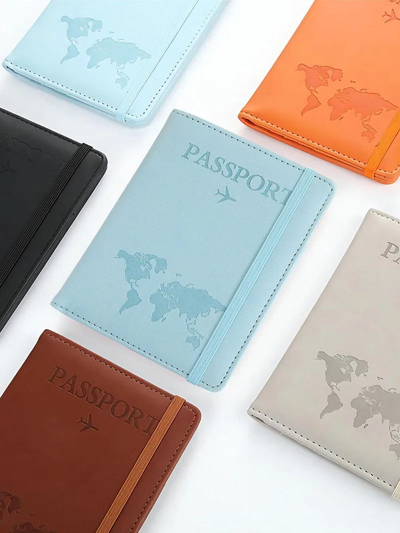 A collection of leather passport holders in blue, orange, and brown colors displayed on a white surface.