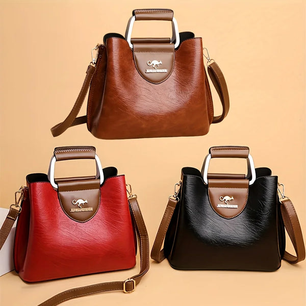 A brown leather vintage multi-pocket crossbody tote bag with a silver handle and a small embossed logo.
