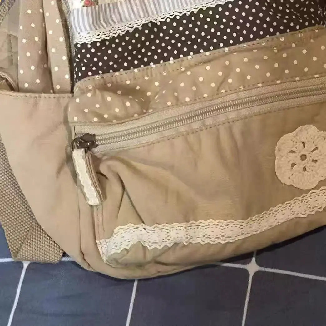 A close-up view of a beige backpack with floral print accents and light beige fabric details.