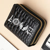 Black fashion PU leather double zipper wallet with gold stitching shown diagonally on a light background