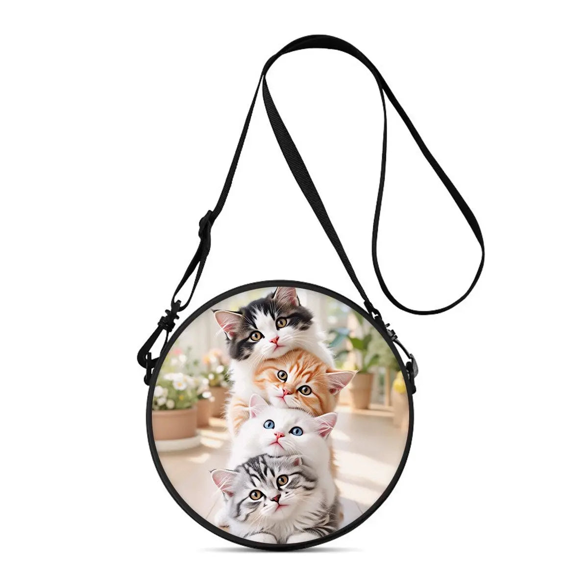 A black strap is attached to a round bag featuring two kittens, one black and one orange.