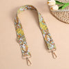 An adjustable bohemian printed crossbody strap featuring yellow, orange, and white floral patterns.