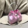 A pink crystal-embellished evening clutch with a silver chain is displayed against a neutral background.