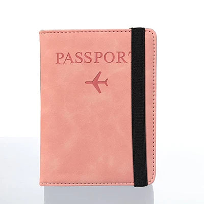 A pink leather passport holder with a black strap and a stylized airplane icon.