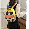 A woman is shown from the back wearing a yellow and white cow print fashion backpack.