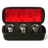 Black watch organizer case with red velvet lining holding three silver watches.