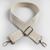A beige woven strap with an arrow jacquard pattern, folded and displayed against a light gray background.