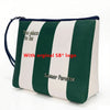 Bolsa cosmética a rayas verdes y blancas con el texto 'The place to be' y 'Summer Paradise'