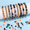 A collection of colorful polymer clay bracelets in various patterns and colors laid out on a light blue background.