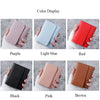 A display of various colored slim multi-functional card wallets including purple, light blue, red, black, pink, and brown.