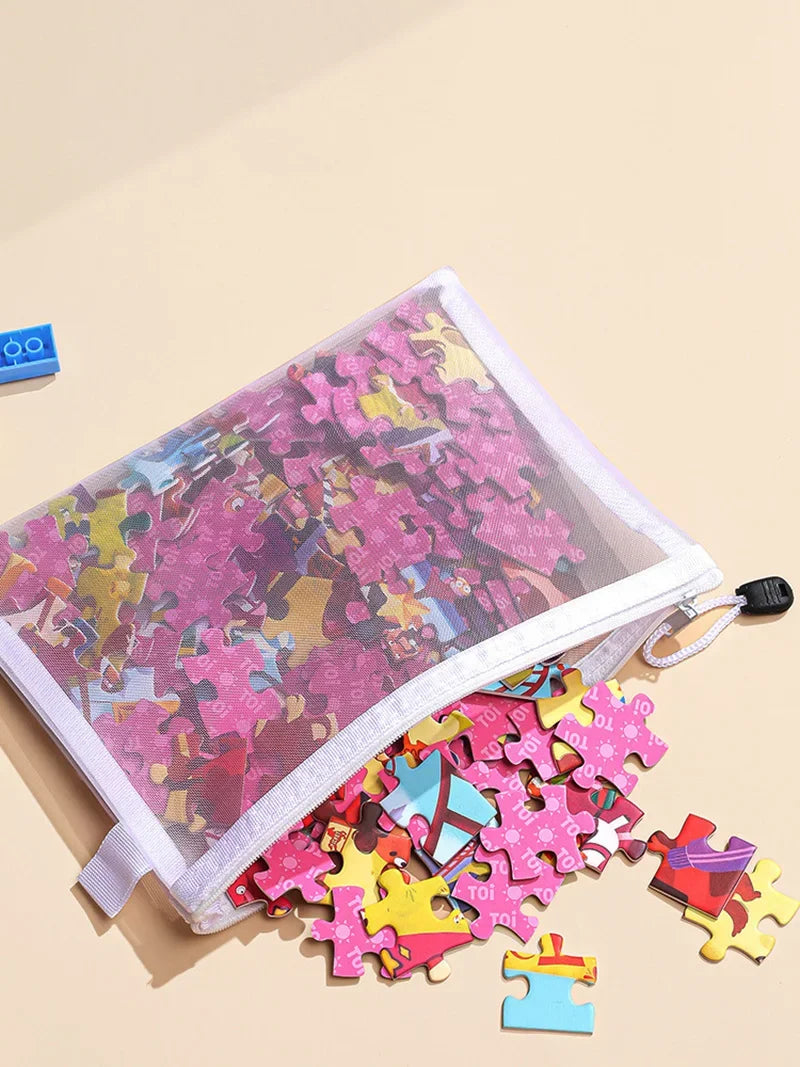 A clear mesh zipper pouch filled with colorful puzzle pieces on a light beige background.