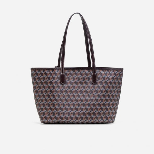A taupe geometric patterned tote bag with brown leather handles.