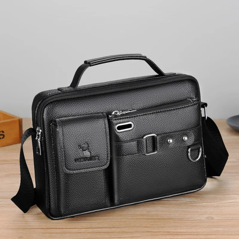 Black men's PU leather crossbody shoulder bag with a flap and strap resting on a wooden surface.