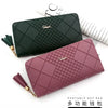 A dark green quilted clutch wallet and a mauve quilted clutch wallet are displayed on a white background.