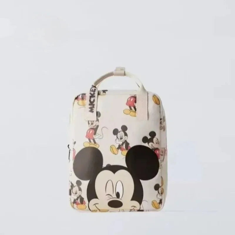 A white backpack featuring Mickey Mouse print and a black strap.