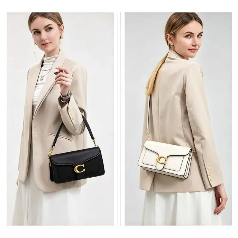 A woman models a beige blazer and white skirt, holding a premium textured shoulder bag.