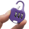 A purple compact 3-digit combination travel lock is held by a person's fingers.