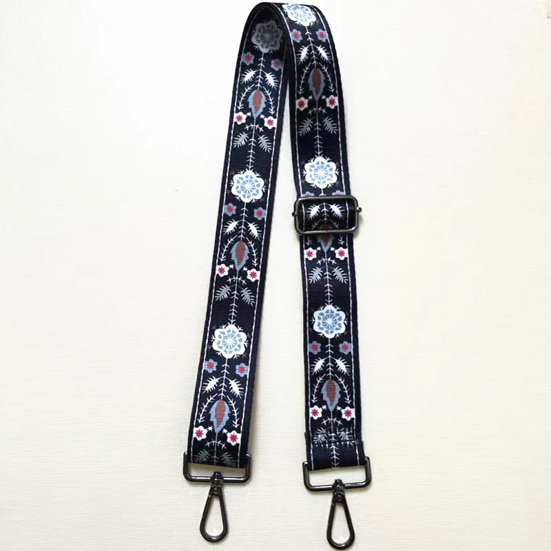 A dark blue textile replacement bag strap with a patterned design and a silver buckle.