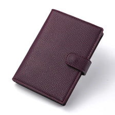 A dark purple leather multi-card travel wallet with a stitched texture and a fold-over closure.