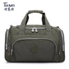 A dark olive green nylon travel duffle bag with padded straps and zippered compartments.