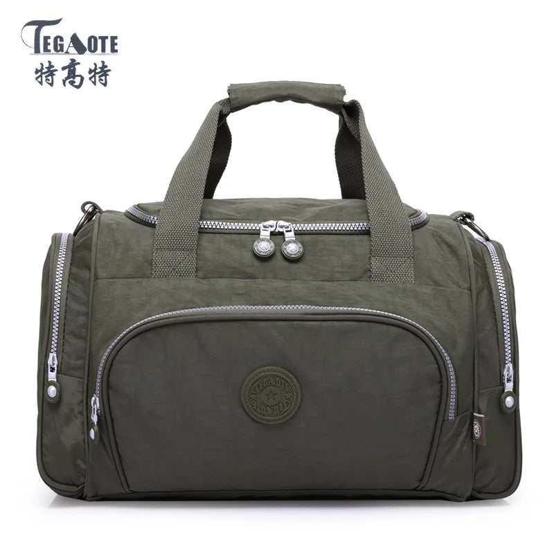 A dark olive green nylon travel duffle bag with padded straps and zippered compartments.
