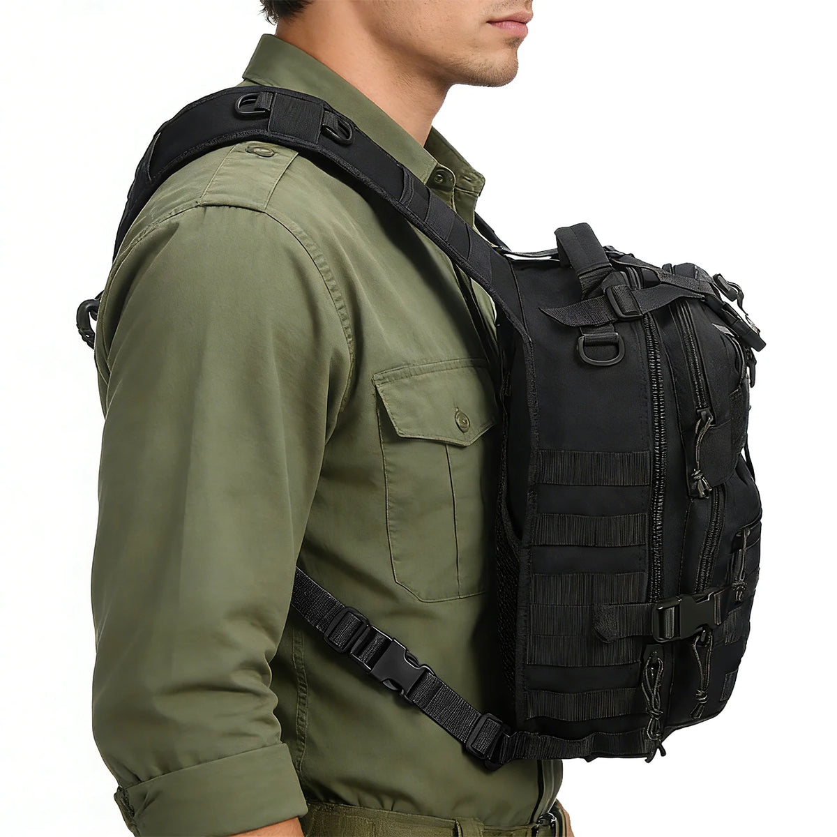 A person wearing a olive green shirt and black multi-compartment crossbody bag with tactical straps.