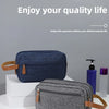 A navy blue and gray portable travel storage pouch for cosmetics is displayed on a white surface.
