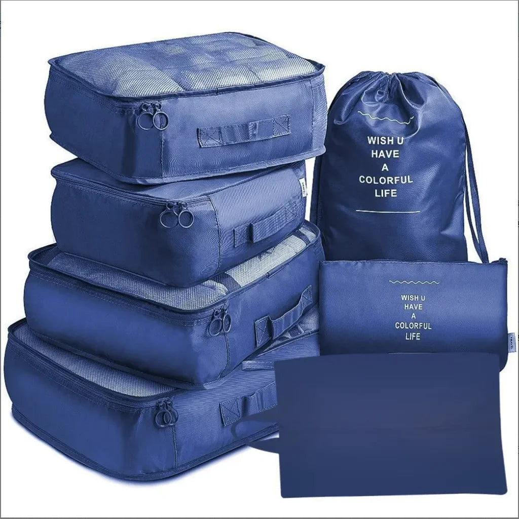 A set of seven blue fabric storage bags and a drawstring bag for travel organization.