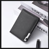 A black slim vertical men's card wallet resting on a white surface next to a magazine.