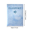 Light blue marble print passport card holder with a stitched edge and a stylized airplane design