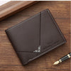 A dark brown men's slim leather bifold wallet resting on a wooden surface next to a gold pen.