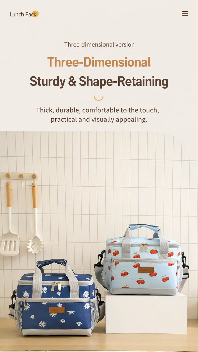 A blue and white insulated thermal lunch bag with a handle is displayed on a white pedestal.