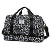 A black and gray leopard print travel duffel bag with a zippered compartment and carrying straps.