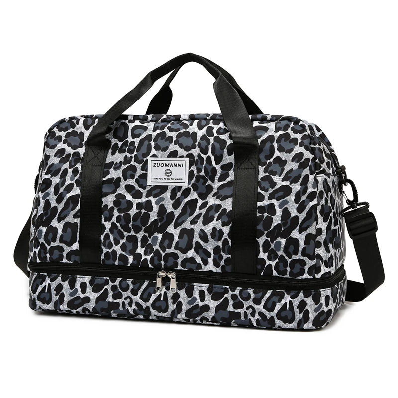 A black and gray leopard print travel duffel bag with a zippered compartment and carrying straps.