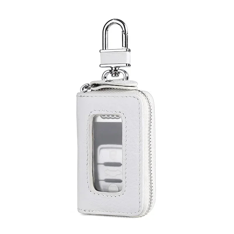 A white leather car key case with a silver padlock and transparent window.