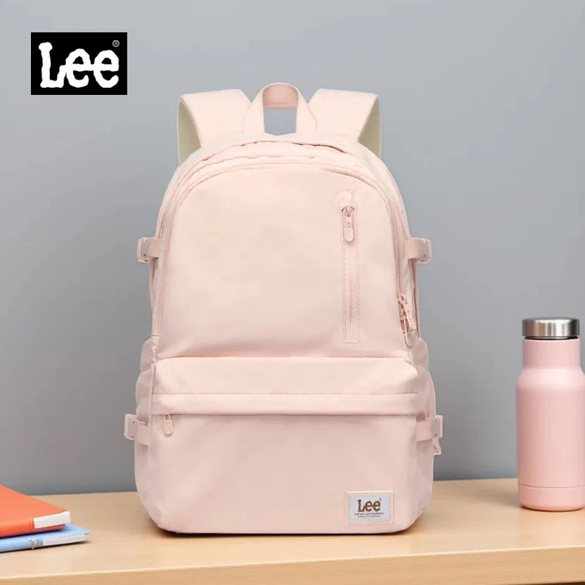 A light pink Lee unisex oxford school backpack with a laptop sleeve displayed on a wooden surface.