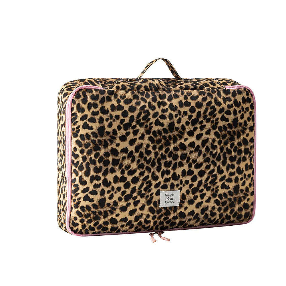 A leopard print large capacity waterproof travel makeup organizer bag with pink trim.