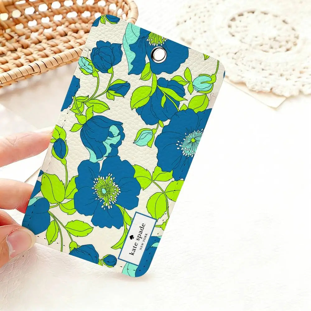 A teal and lime green floral pattern card holder featuring blue flowers and leaves.