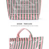 A pink and green striped tote bag with a canvas texture is shown against a white background.