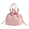 A pink insulated drawstring lunch bag with multiple pockets and fabric handles.