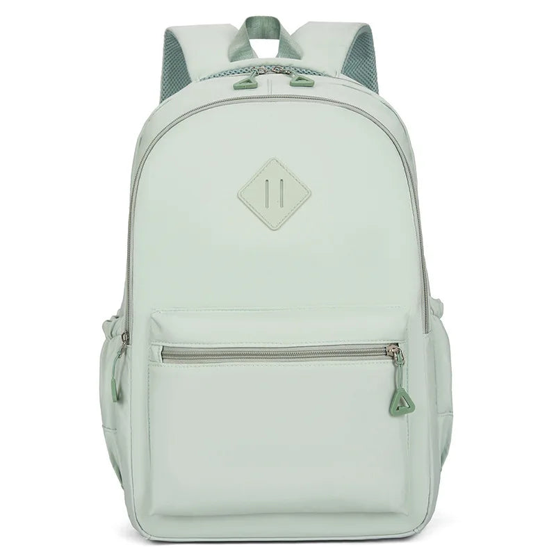 A light mint green durable nylon commuter backpack with a gray strap and diamond-shaped logo.