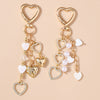 Gold-toned pearl bow heart keychain with a chain and heart charms