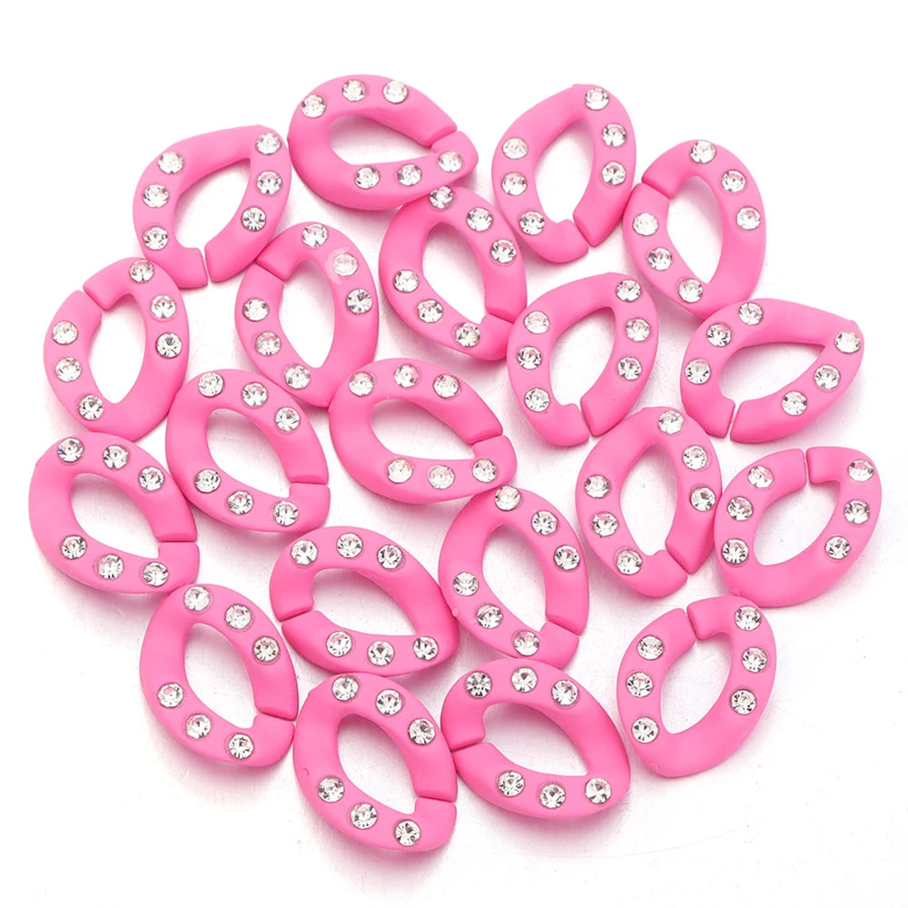 A pile of pink acrylic link chains with clear rhinestones for DIY jewelry making