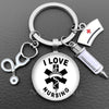 Silver keychain featuring a circular charm with a black medical cross and the words I LOVE NURSING